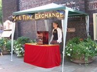 image of stall/gazeebo with time exchange banner and table